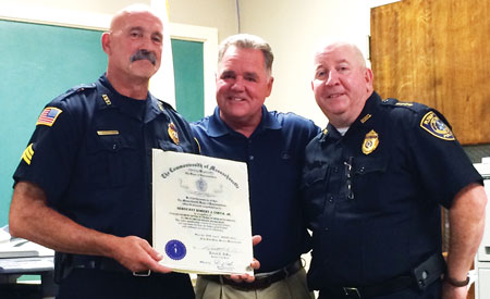 Representative Thomas J. Calter, center, presented retiring Plympton Sgt. Robert Costa, left, a Proclamation from the Massachusetts House of Representatives during Monday night’s meeting of the Board of Selectmen. Adding his good wishes to the 30-year veteran is Plympton Police Chief Patrick Dillon, right.